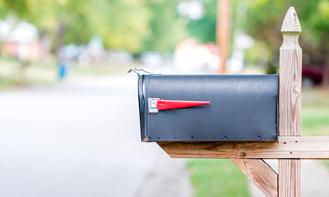 residential-black-mailbox-with-red-flag-wood-post