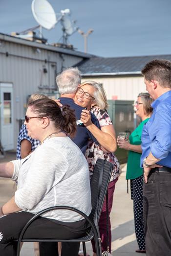 Pam hugging a Realtor during the Appleton 10 year anniversary celebration