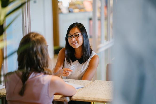 two-female-business-colleagues-talking-in-conference-room