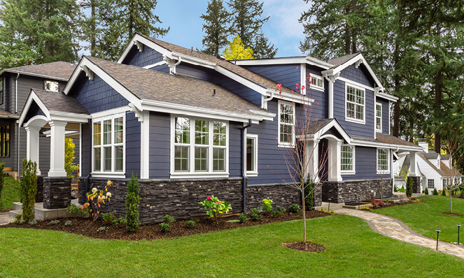 blue-house-white-trim-new-construction-green-grass-trees