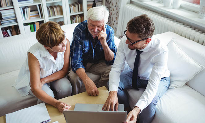 advisor-talking-with-elderly-couple-at-home