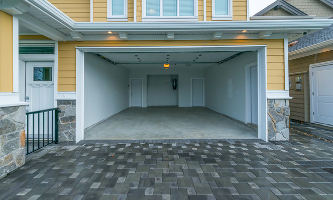 empty-home-garage-brick-driveway-yellow-house-exterior