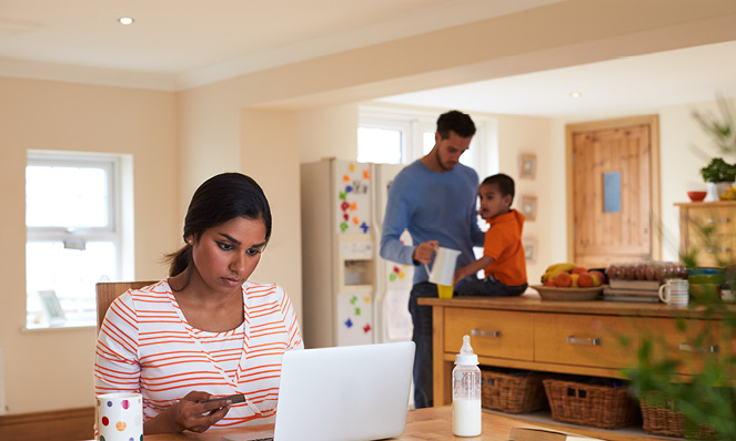 family-in-kitchen-mother-looking-at-laptop-kitchen-table