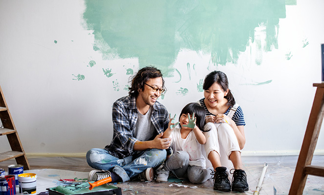 family-of-three-painting-wall-light-green