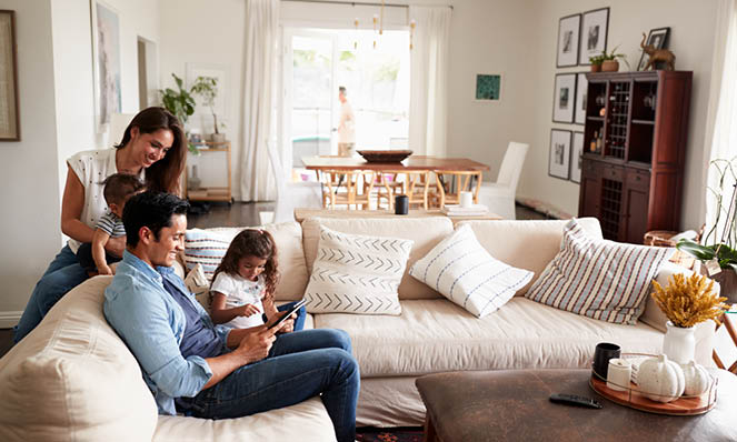 family-sitting-open-living-room-tablet