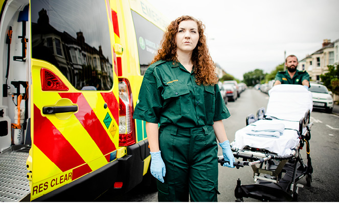 first-responder-female-green-overalls-blue-protective-gloves
