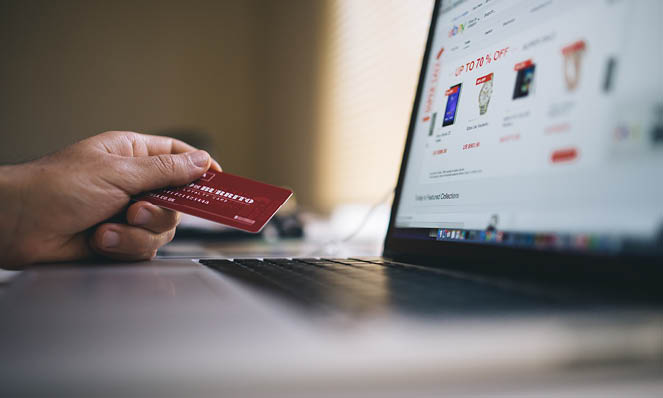 holding-red-credit-card-shopping-online
