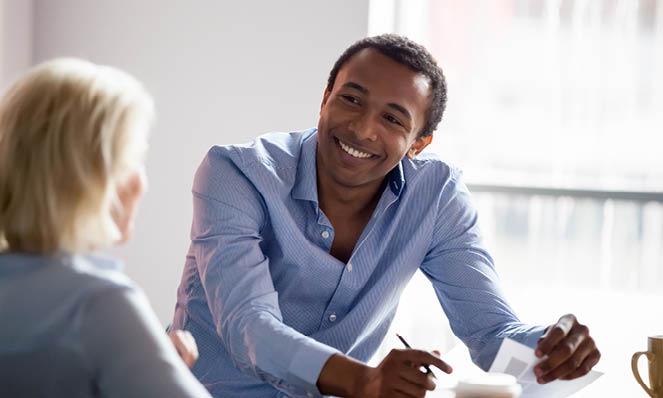 smiling-attractive-man-with-pen-talking-to-advisor