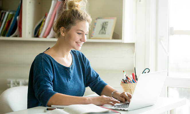 Young happy woman at home getting pre-approved for mortgage loan