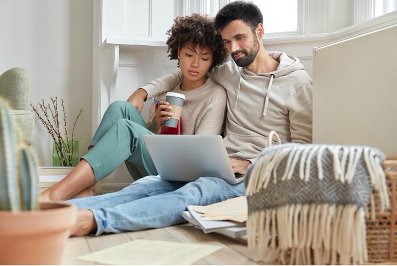couple-looking-at-mortgage-down-payment-assistance-programs-on-laptop