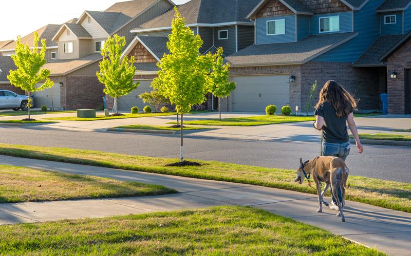 Woman walking dog neighborhood