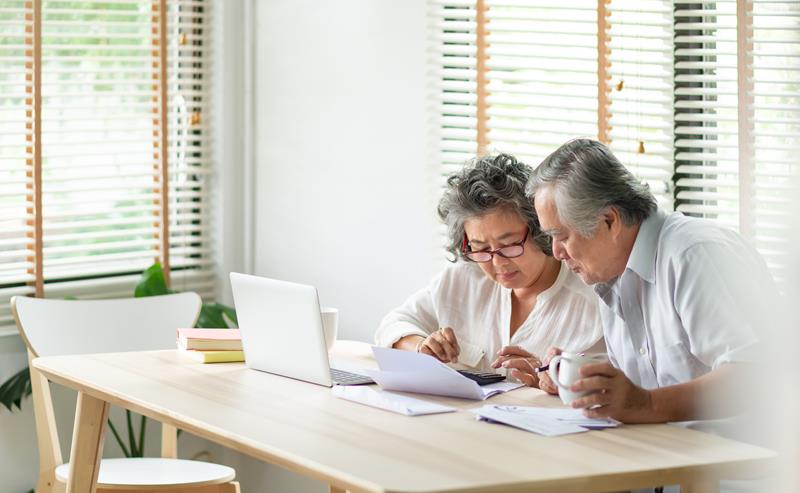 Senior couple looking at home financial numbers