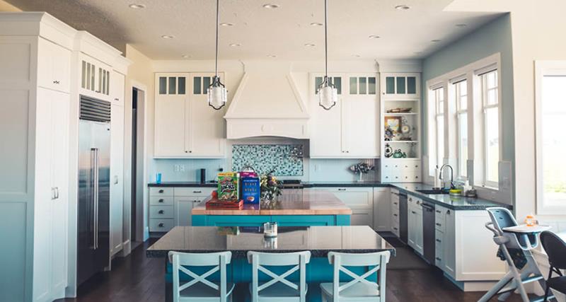 light-blue-home-kitchen-with-seating-area-mosaic-backsplash-white-cabinets