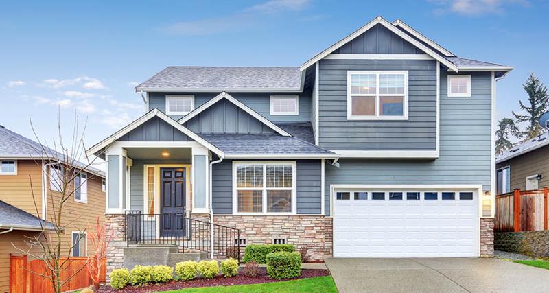 split-level-home-blue-door-green-lawn